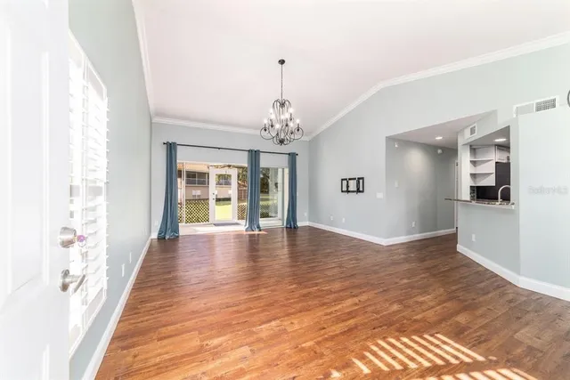 a view of a room with wooden floor and large windows