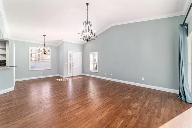 a view of a kitchen with kitchen island a sink stainless steel appliances and cabinets