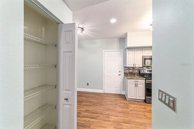 a kitchen with stainless steel appliances granite countertop a sink a stove and a refrigerator