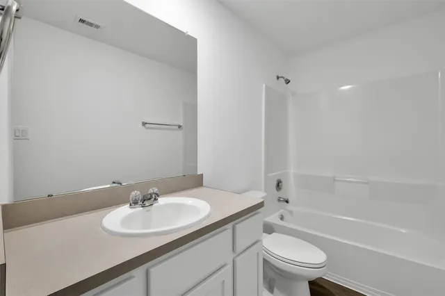 a bathroom with a sink toilet tub and shower