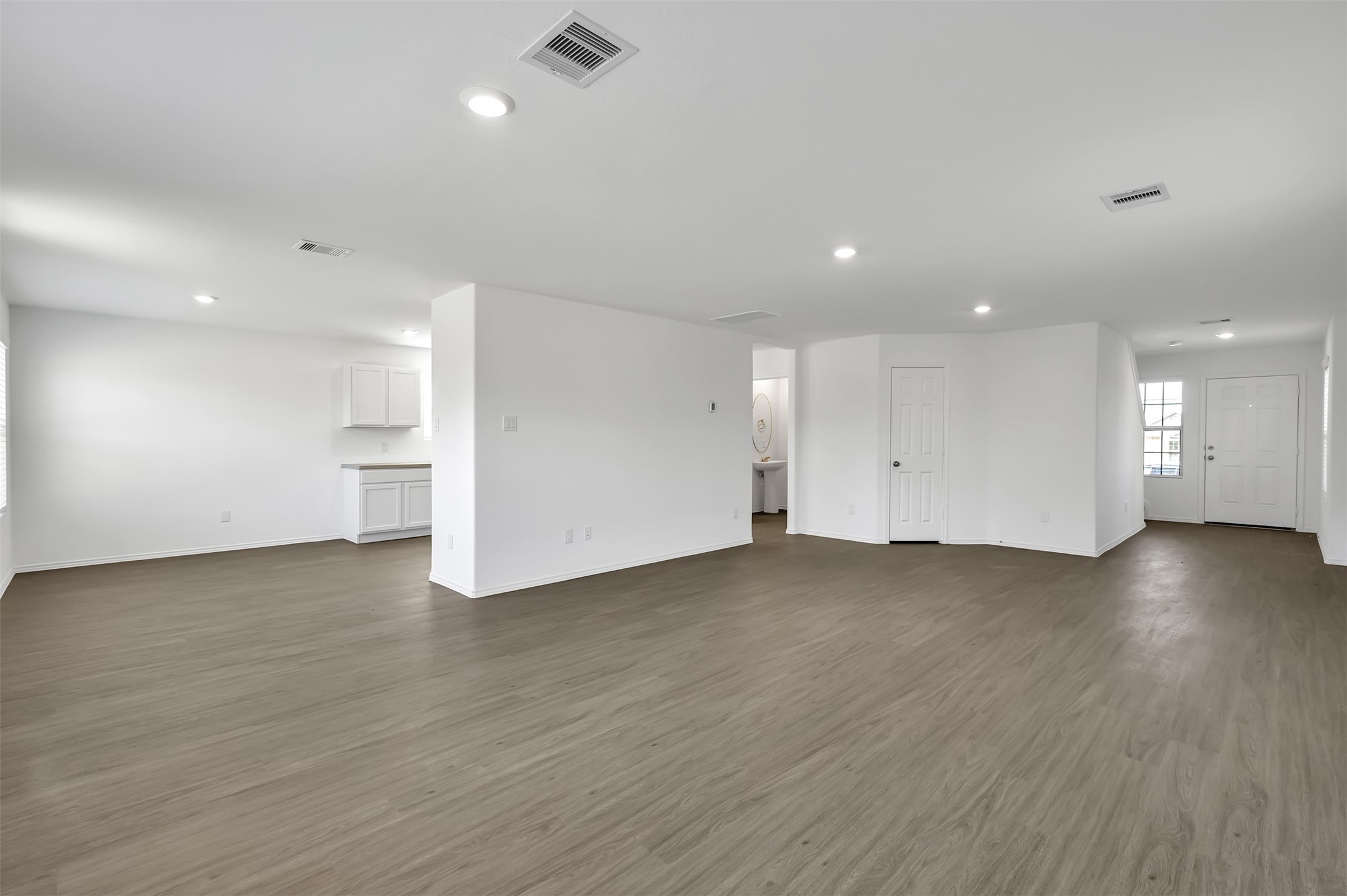 3647 Solanum Drive Conroe, TX 77301 - Photo 4 of 17 an empty room with wooden floor and windows