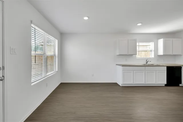 a view of kitchen with wooden floor and electronic appliances
