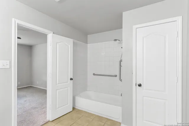 a white bath tub sitting next to a white tub