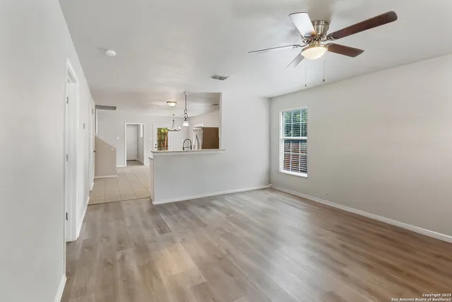 a view of a kitchen with an empty space and a ceiling fan