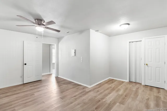 a view of an empty room and wooden floor