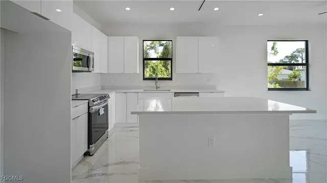 a kitchen with a sink appliances and cabinets