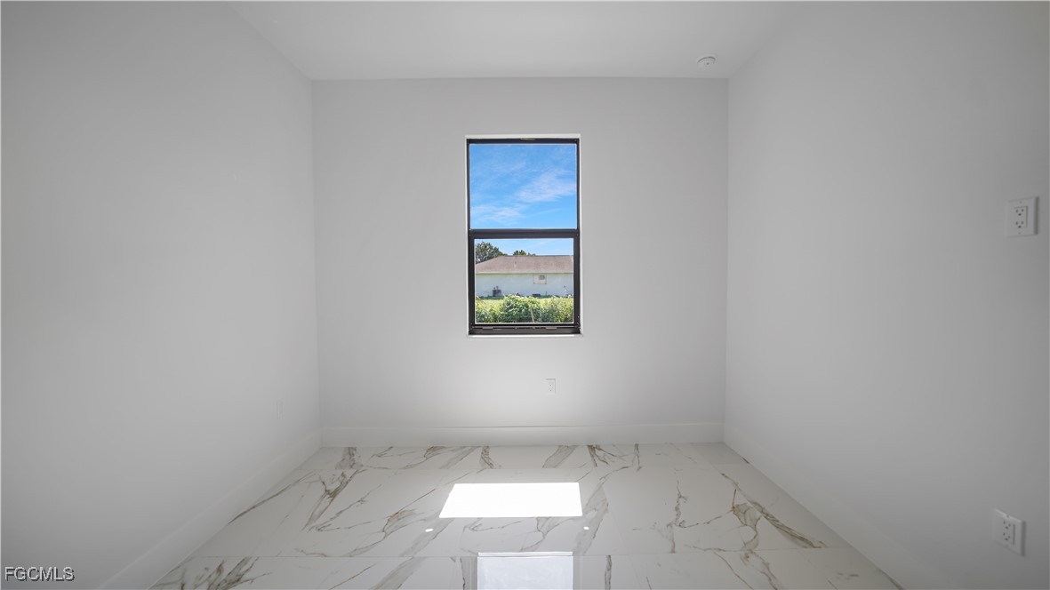 121 Ichabod Avenue Lehigh Acres, FL 33973 - Photo 28 of 42 an empty room with windows