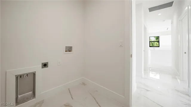 an empty room with white walls and shower