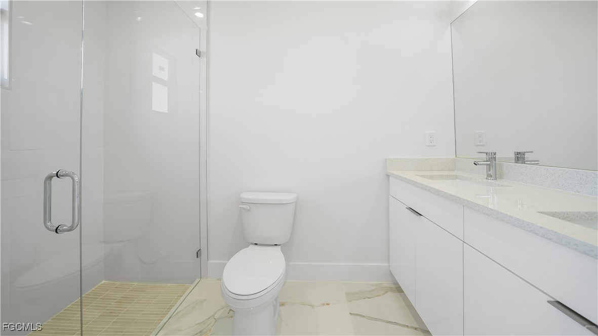 121 Ichabod Avenue Lehigh Acres, FL 33973 - Photo 41 of 42 a bathroom with a sink toilet and shower