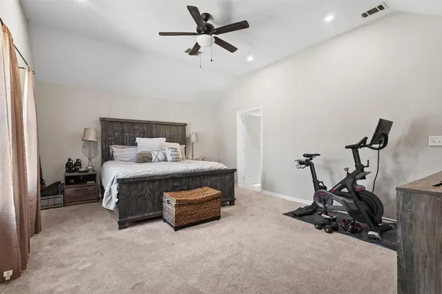 a bedroom with furniture and a gym equipment