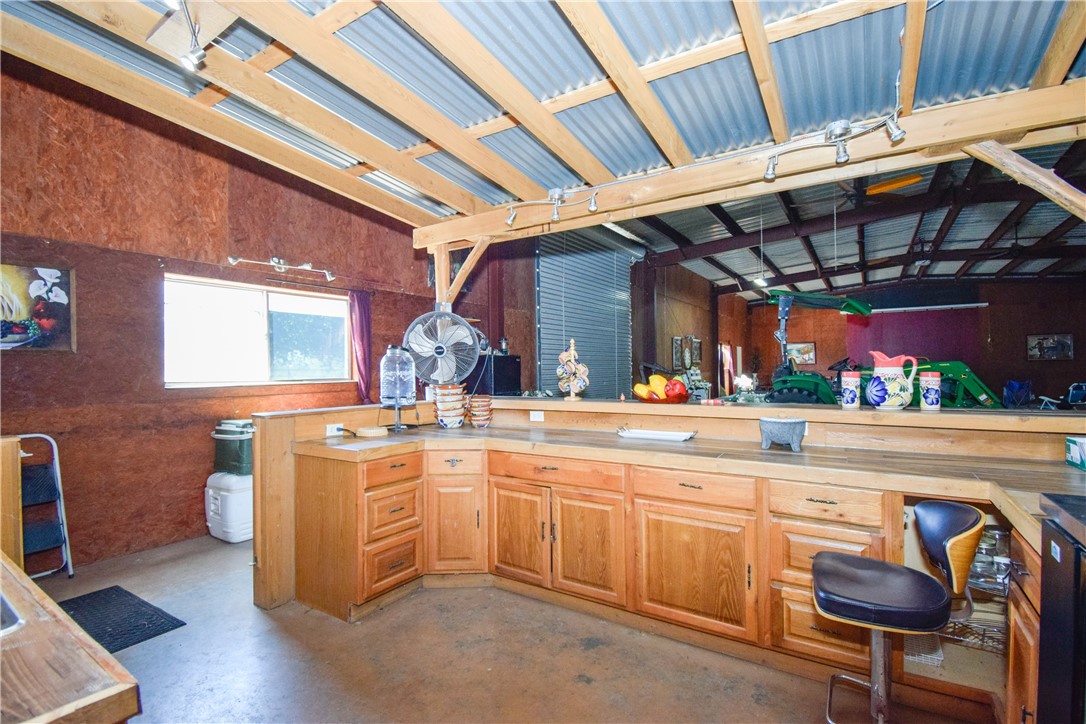23250 County Road 1038 Mathis, TX 78368 - Photo 12 of 40 a kitchen with sink and chairs