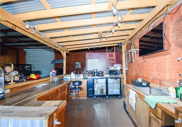 a kitchen with sink and chairs
