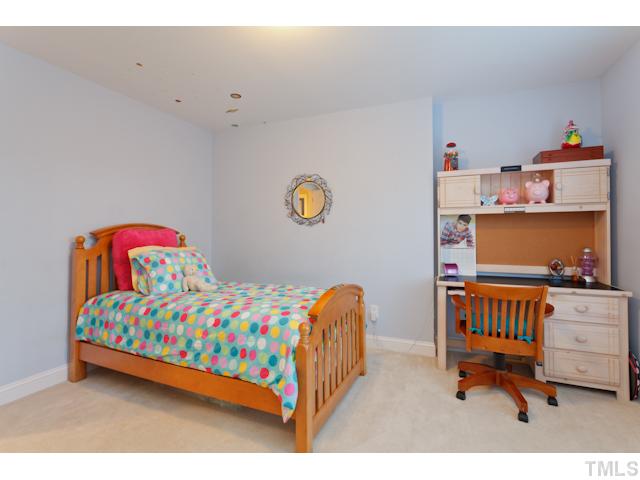 7613 Double E Court Raleigh, NC 27613 - Photo 16 of 23 a bedroom with a bed and wooden floor