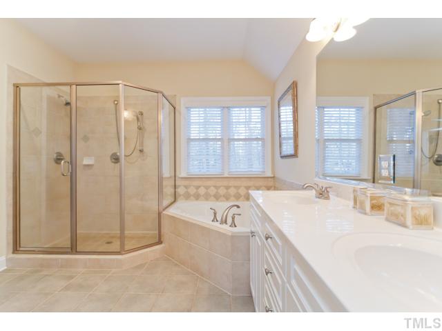 7613 Double E Court Raleigh, NC 27613 - Photo 19 of 23 a bathroom with a tub a sink and mirror