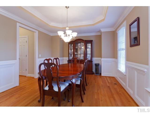 7613 Double E Court Raleigh, NC 27613 - Photo 3 of 23 a view of a dining room with furniture a chandelier and wooden floor