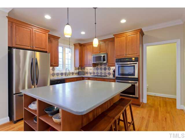7613 Double E Court Raleigh, NC 27613 - Photo 6 of 23 a kitchen with stainless steel appliances a table chairs refrigerator and microwave