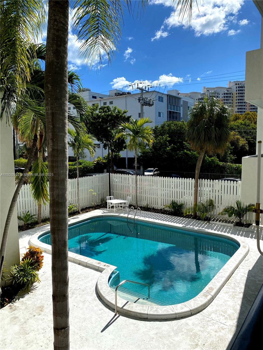 300 Galen Drive, Unit 205 Key Biscayne, FL 33149 - Photo 18 of 20 a view of a swimming pool with a yard