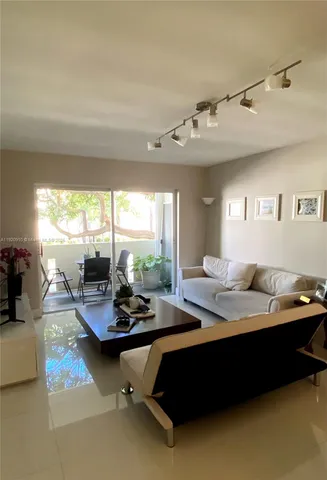 a room with furniture pool table and windows