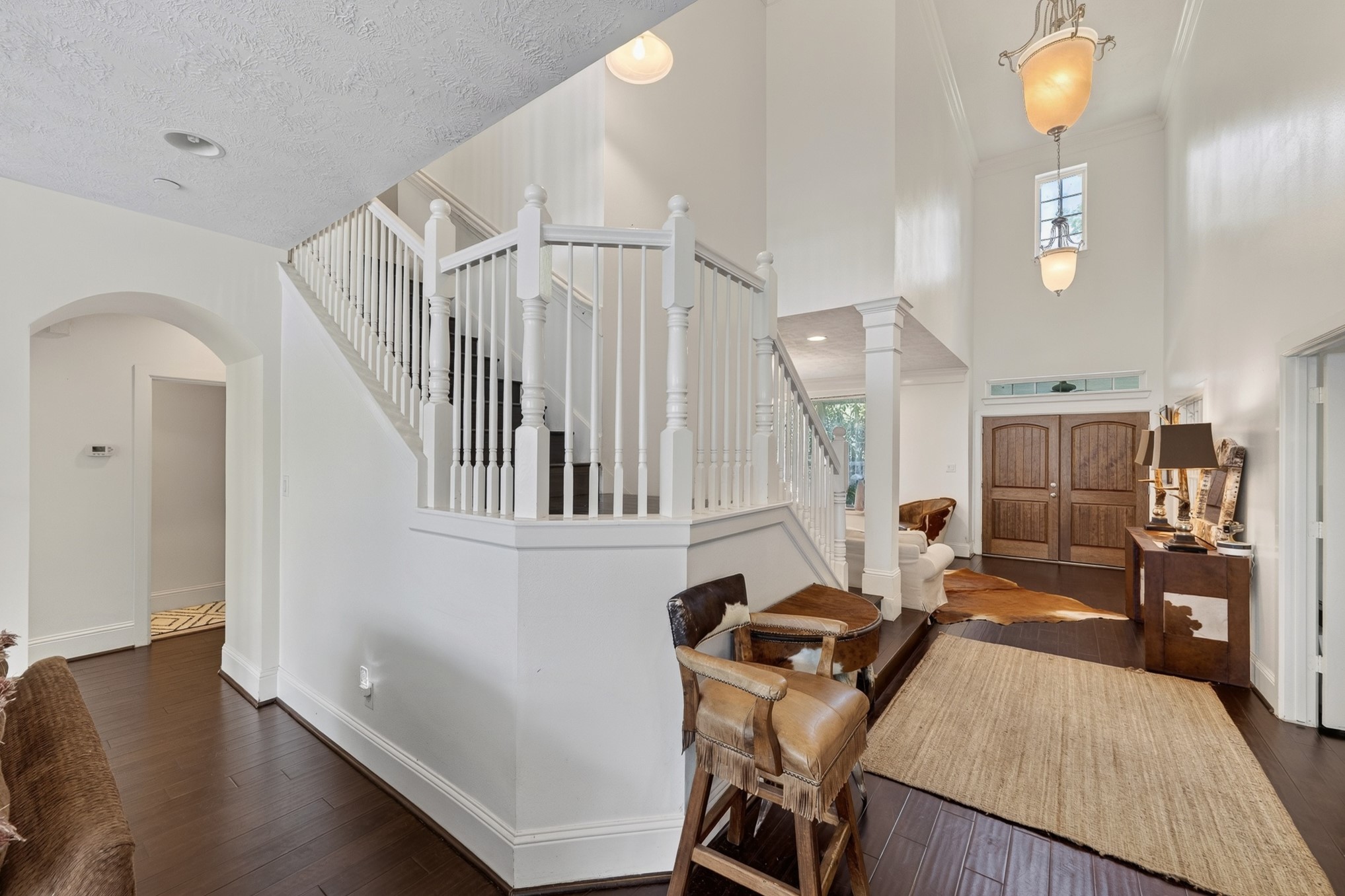 335 Voss Road Houston, TX 77024 - Photo 10 of 50 Gracious interior highlighted by a sweeping staircase and open-concept design.