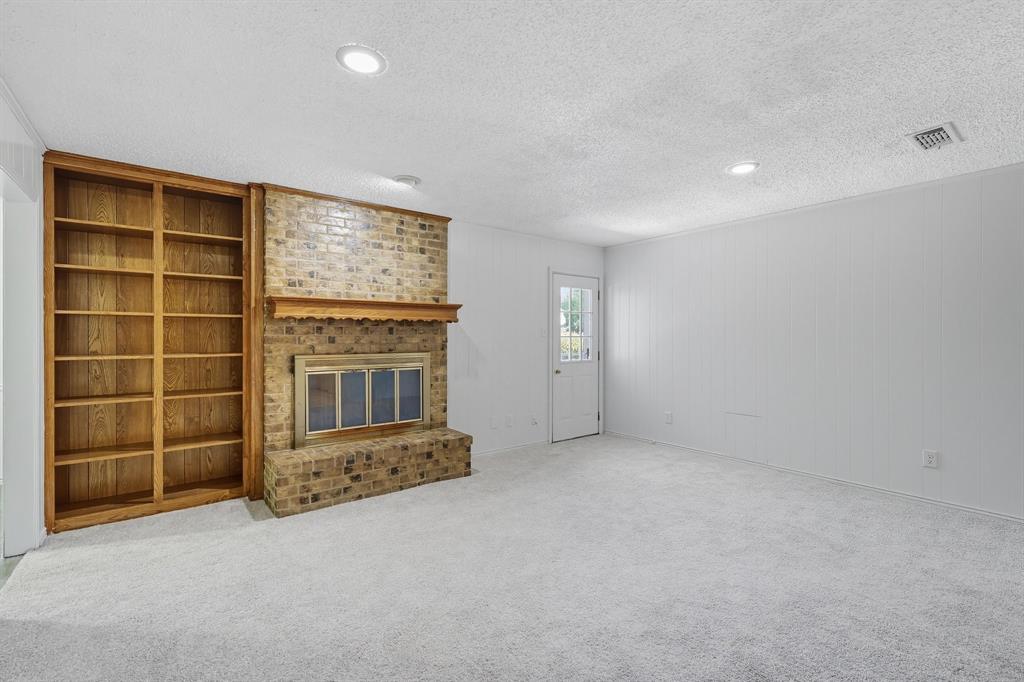 3300 Dunes Street Denton, TX 76209 - Photo 21 of 40 an empty room with a fireplace and window
