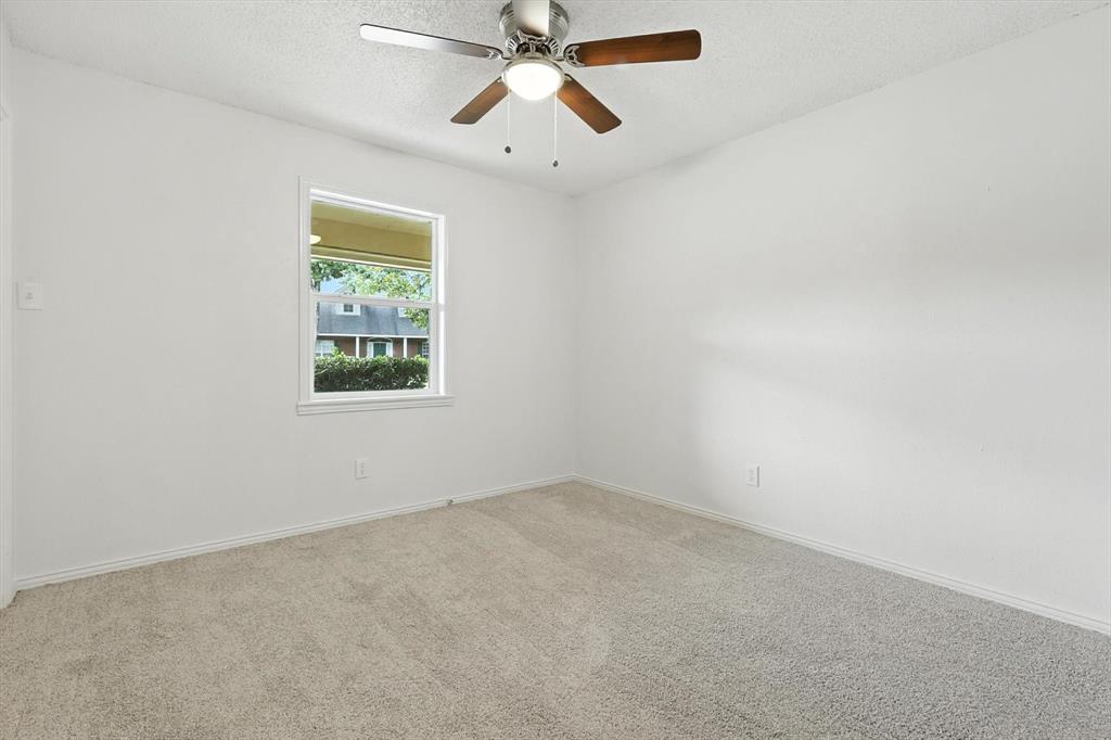 3300 Dunes Street Denton, TX 76209 - Photo 24 of 40 an empty room with windows and fan
