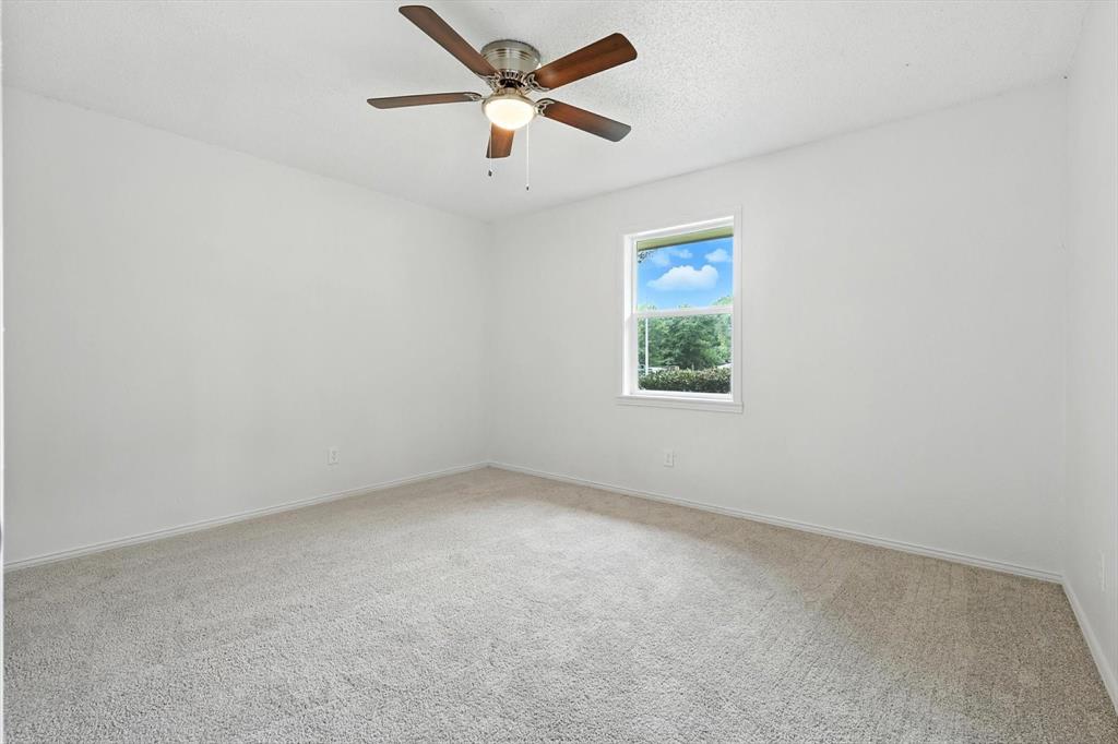 3300 Dunes Street Denton, TX 76209 - Photo 28 of 40 an empty room with a window and a fan