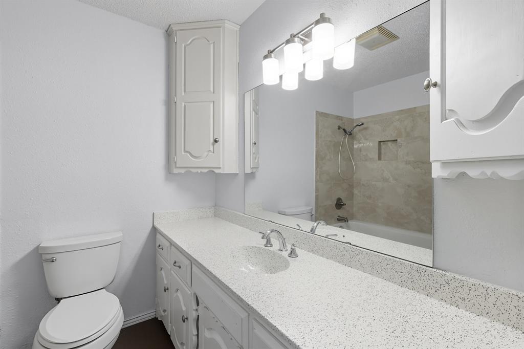 3300 Dunes Street Denton, TX 76209 - Photo 32 of 40 a bathroom with a sink a toilet and shower