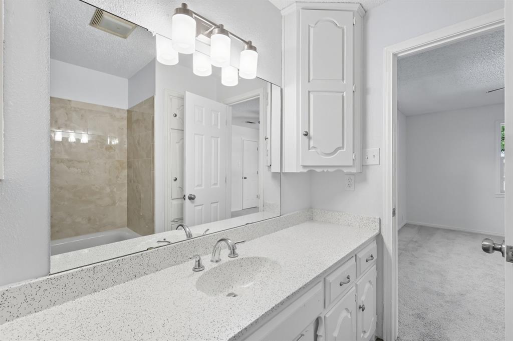 3300 Dunes Street Denton, TX 76209 - Photo 34 of 40 a bathroom with a sink a vanity and a mirror