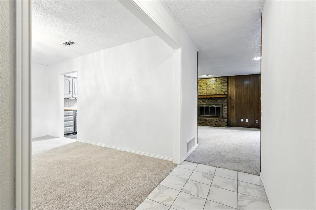 3300 Dunes Street Denton, TX 76209 - Photo 7 of 40 a view of an empty room with a kitchen