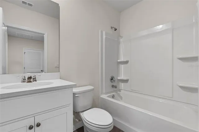 a bathroom with a toilet a sink and a bathtub