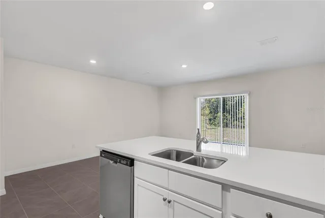 a kitchen with a sink and cabinets