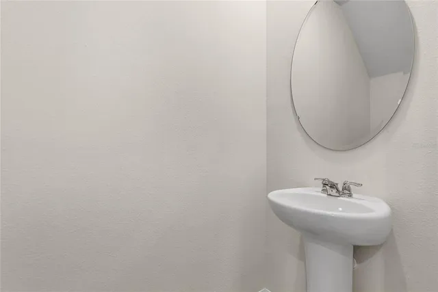 a bathroom with a sink and mirror