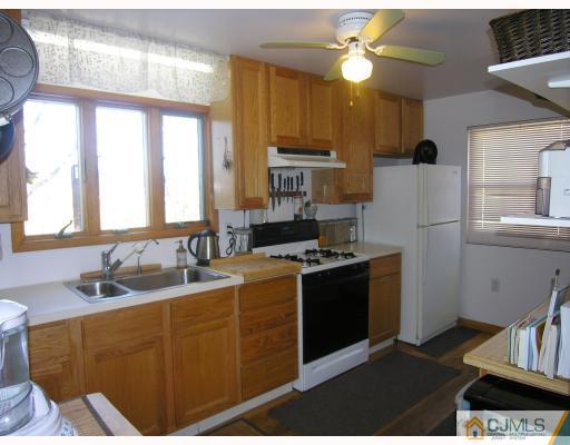50 Wilcox Road New Brunswick, NJ 08901 - Photo 5 of 10 a kitchen with stainless steel appliances granite countertop a sink a stove and a refrigerator