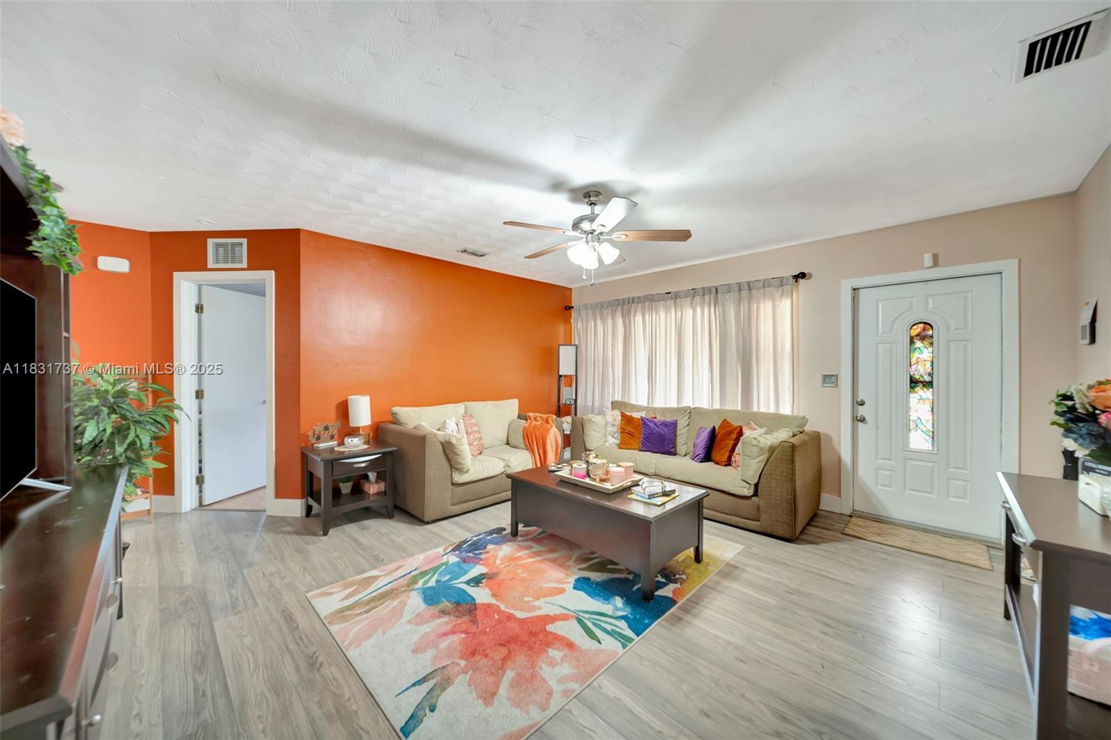 2201 North 57th Terrace Hollywood, FL 33021 - Photo 14 of 14 a living room with furniture and a large window