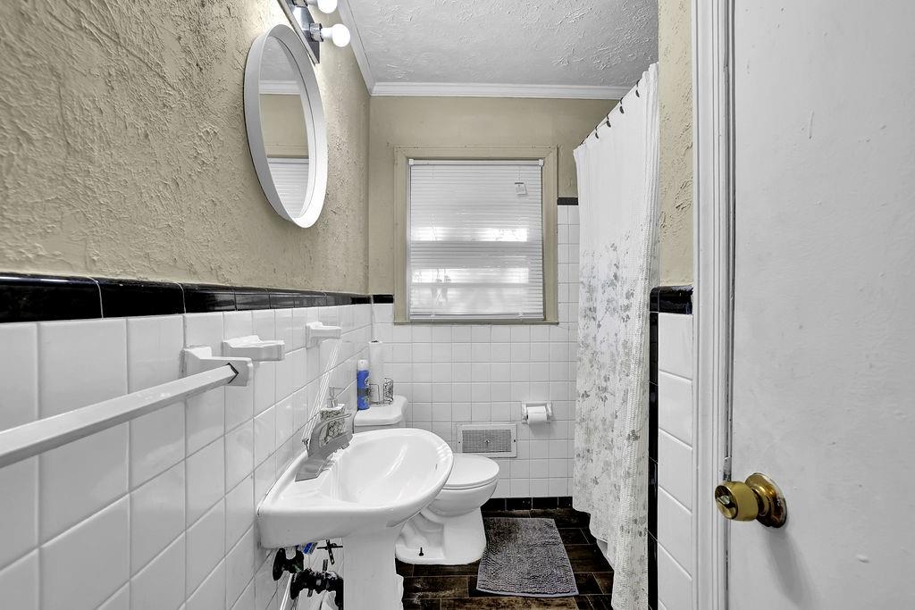 804 Rowland Road Stone Mountain, GA 30083 - Photo 14 of 23 a bathroom with a sink and a mirror