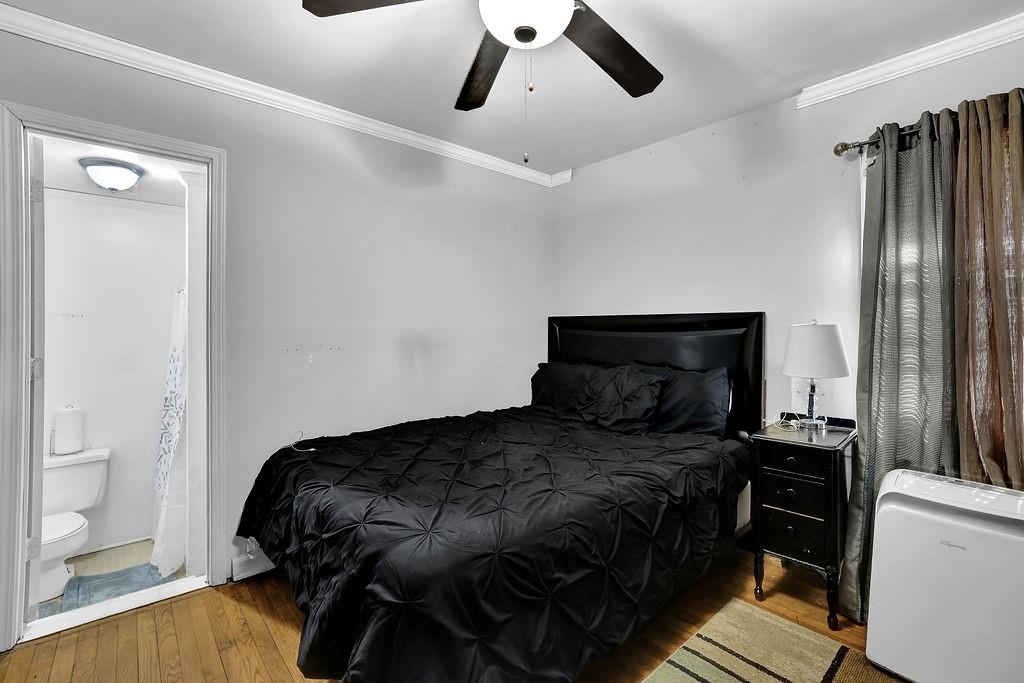 804 Rowland Road Stone Mountain, GA 30083 - Photo 15 of 23 a bedroom with a bed and wooden floor