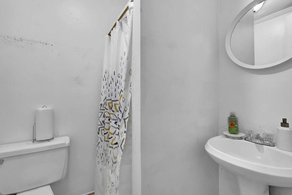 804 Rowland Road Stone Mountain, GA 30083 - Photo 16 of 23 a bathroom with a sink a toilet and shower