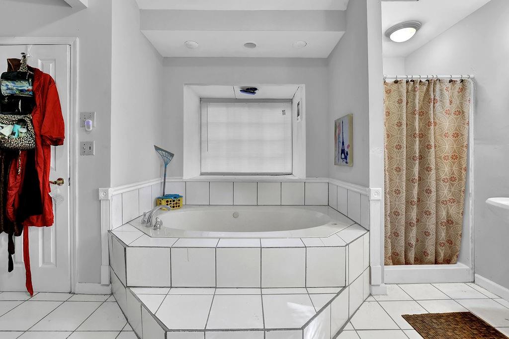 804 Rowland Road Stone Mountain, GA 30083 - Photo 21 of 23 a bathroom with a tub and a shower