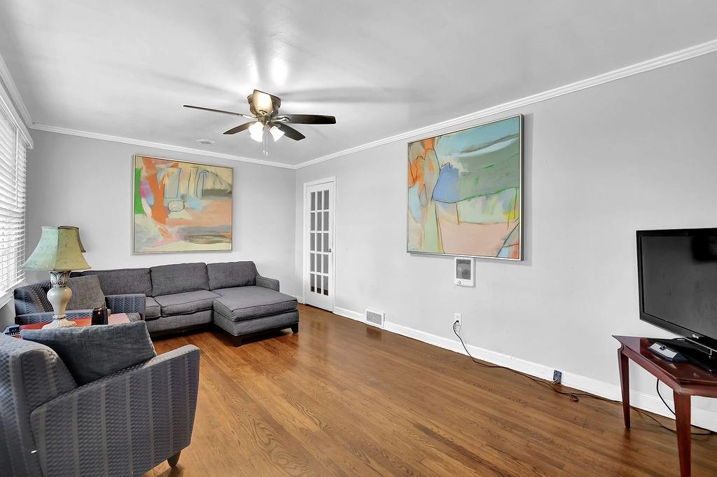 804 Rowland Road Stone Mountain, GA 30083 - Photo 5 of 23 a living room with furniture a ceiling fan and a wooden floor