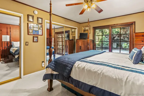 a bedroom with a large bed and a chandelier