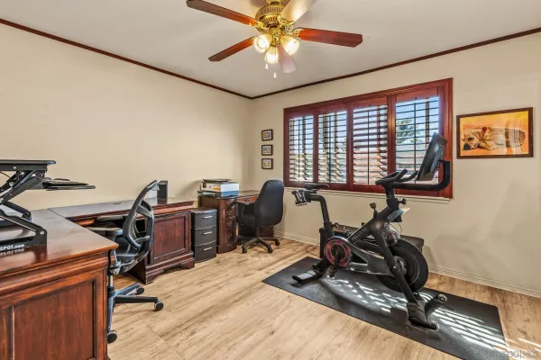 a view of a workspace with furniture and a window