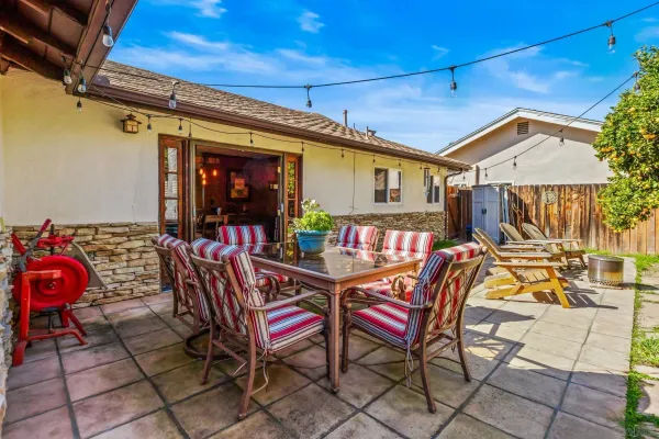a view of a patio with table and chairs with wooden floor