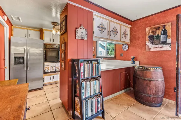 a kitchen with stainless steel appliances granite countertop a refrigerator and a stove