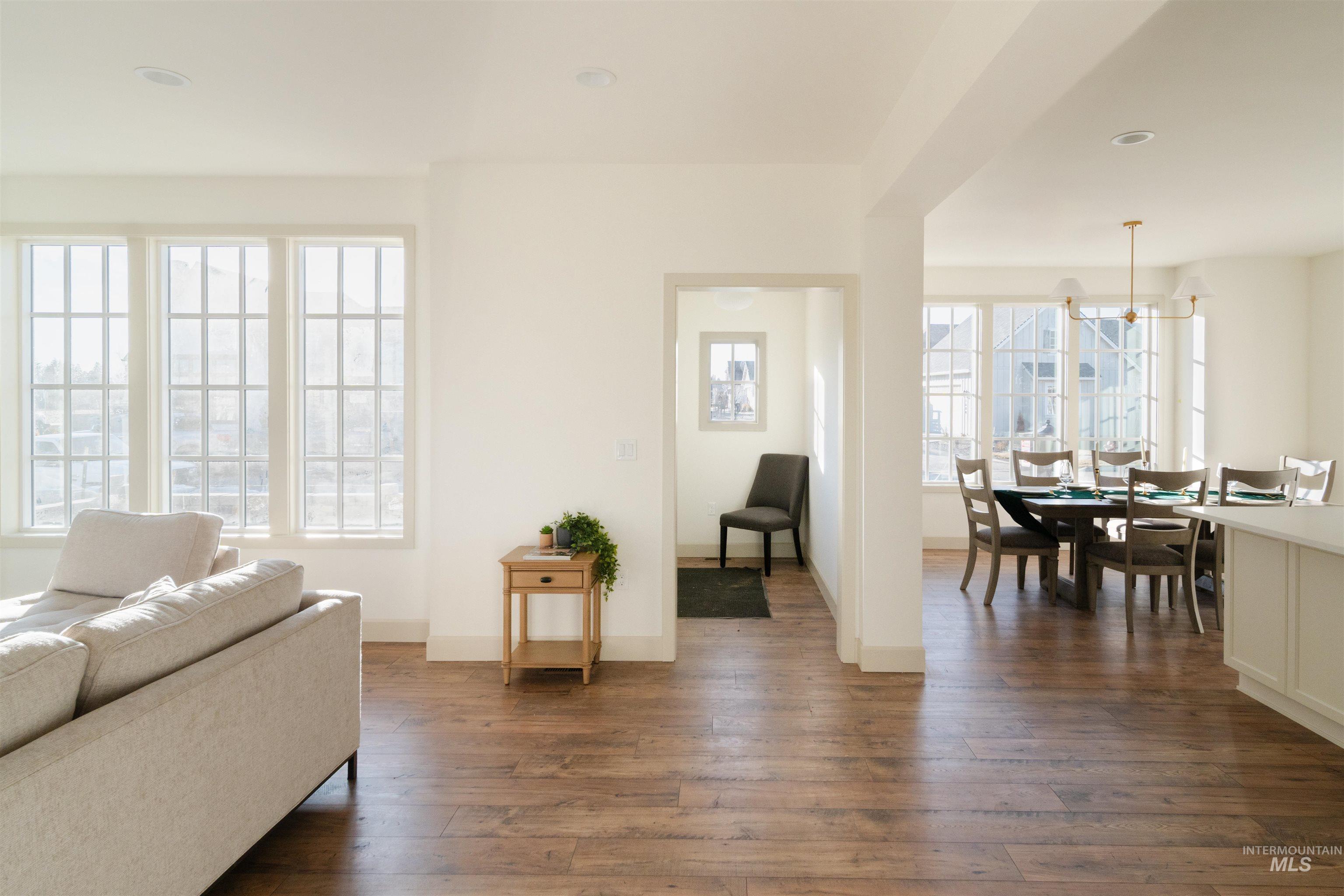 1560 Slonaker, Unit ONYX Moscow, ID 83843 - Photo 13 of 43 Living area with dark wood-type flooring, plenty of natural light, and a chandelier