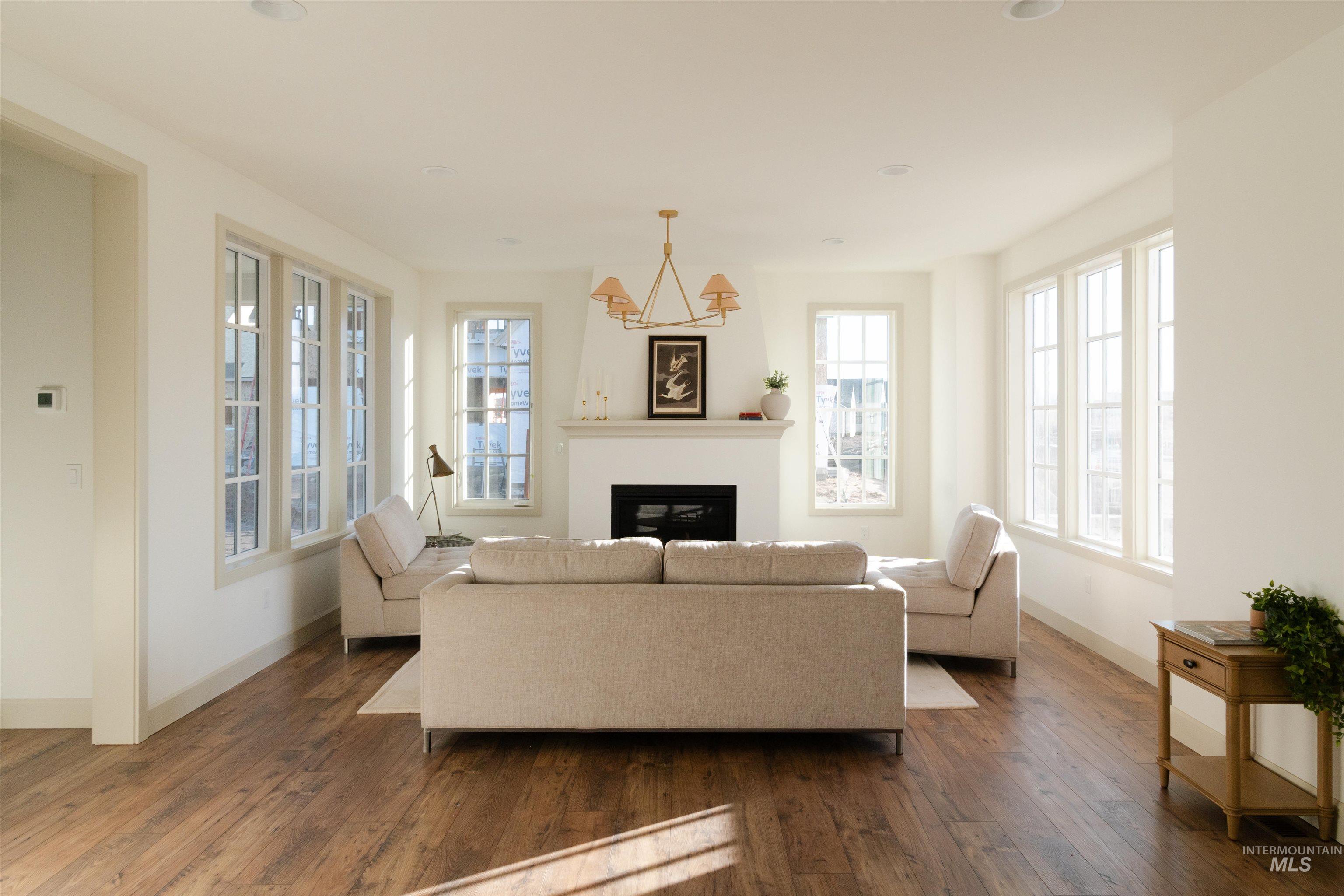 1560 Slonaker, Unit ONYX Moscow, ID 83843 - Photo 14 of 43 Living area with dark wood-style flooring, a glass covered fireplace, and suspended lighting