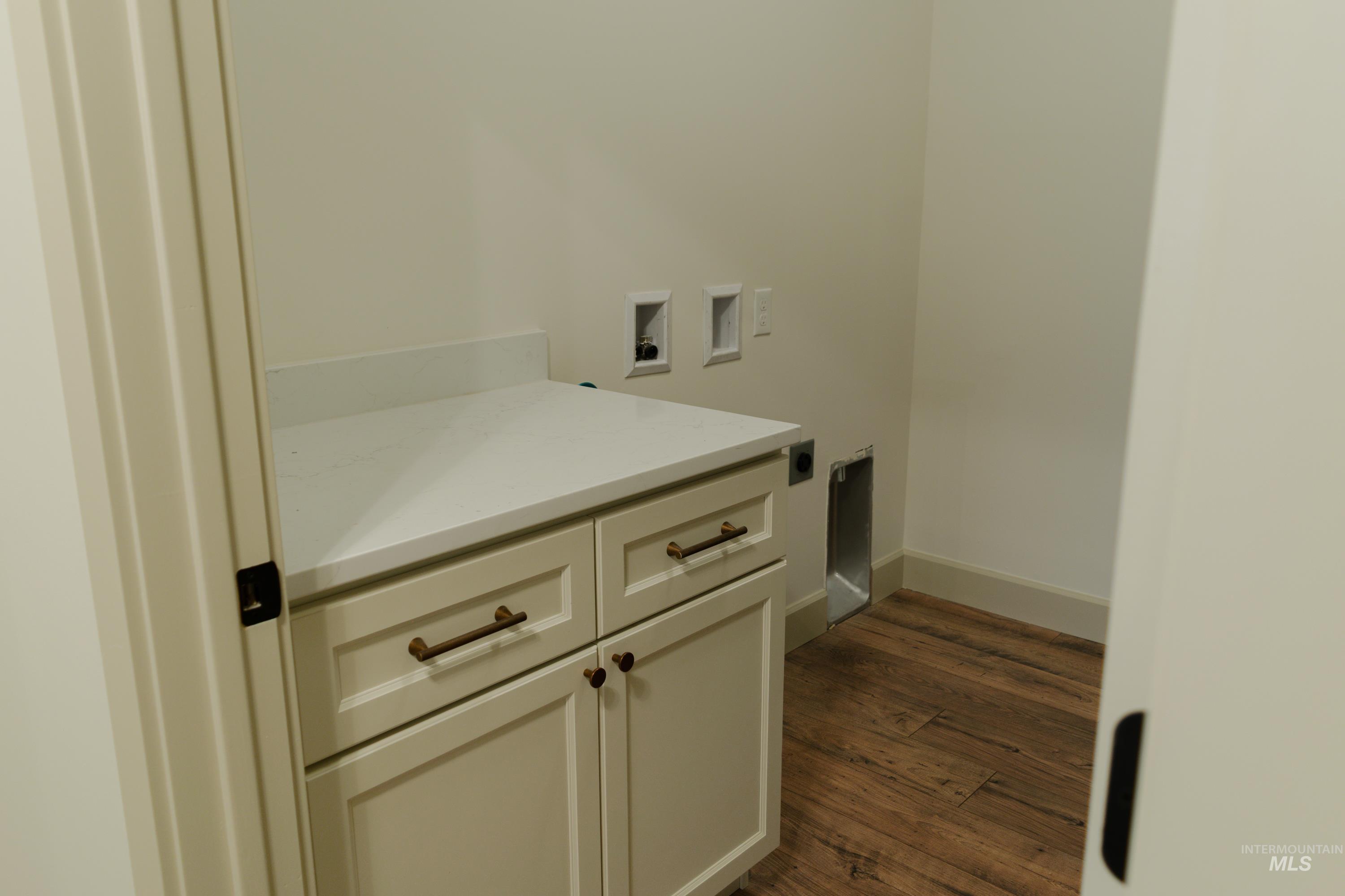 1560 Slonaker, Unit ONYX Moscow, ID 83843 - Photo 16 of 49 Laundry room with washer hookup, dark wood finished floors, and cabinet space