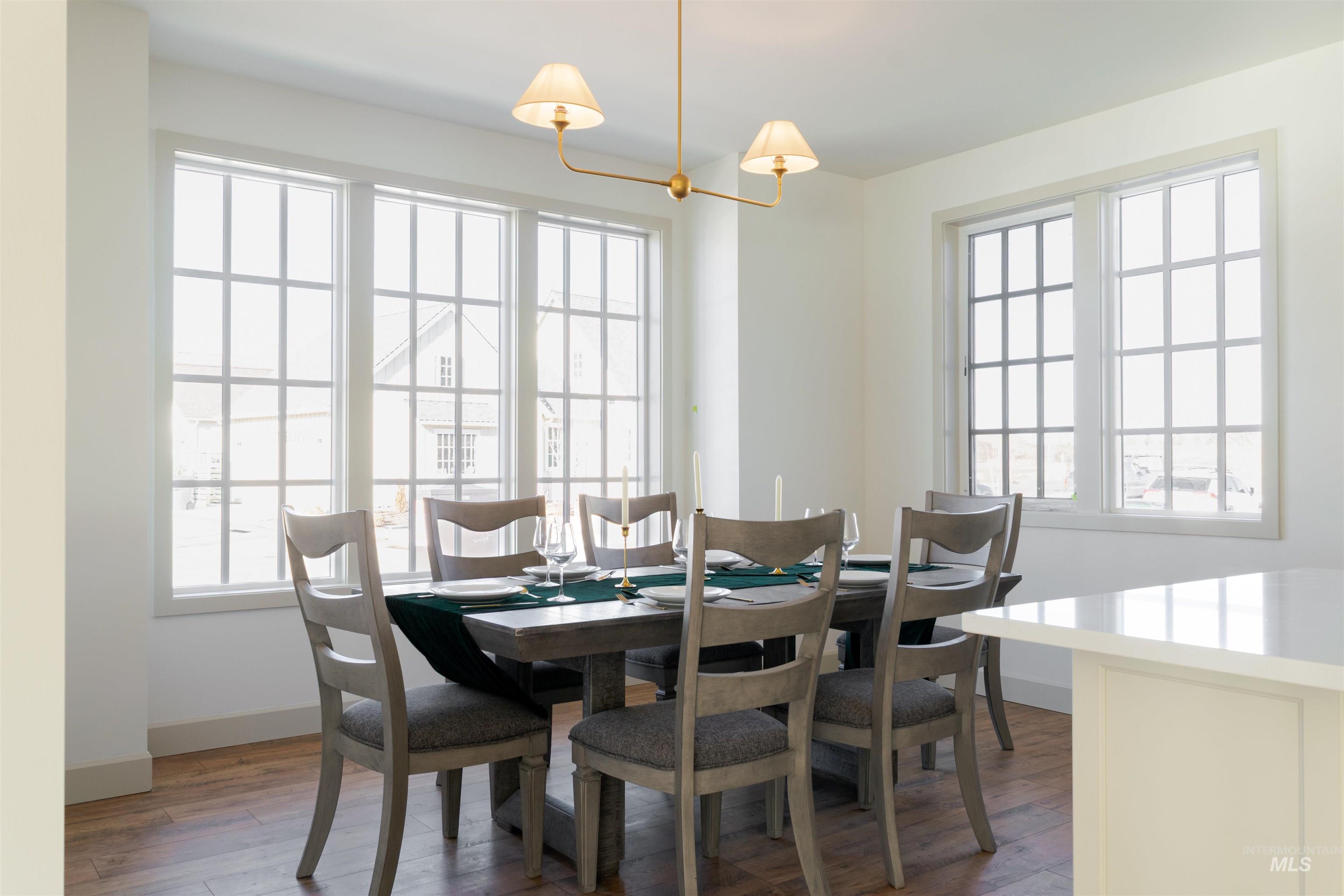 1560 Slonaker, Unit ONYX Moscow, ID 83843 - Photo 16 of 45 Dining space with dark wood-style floors and hanging lights