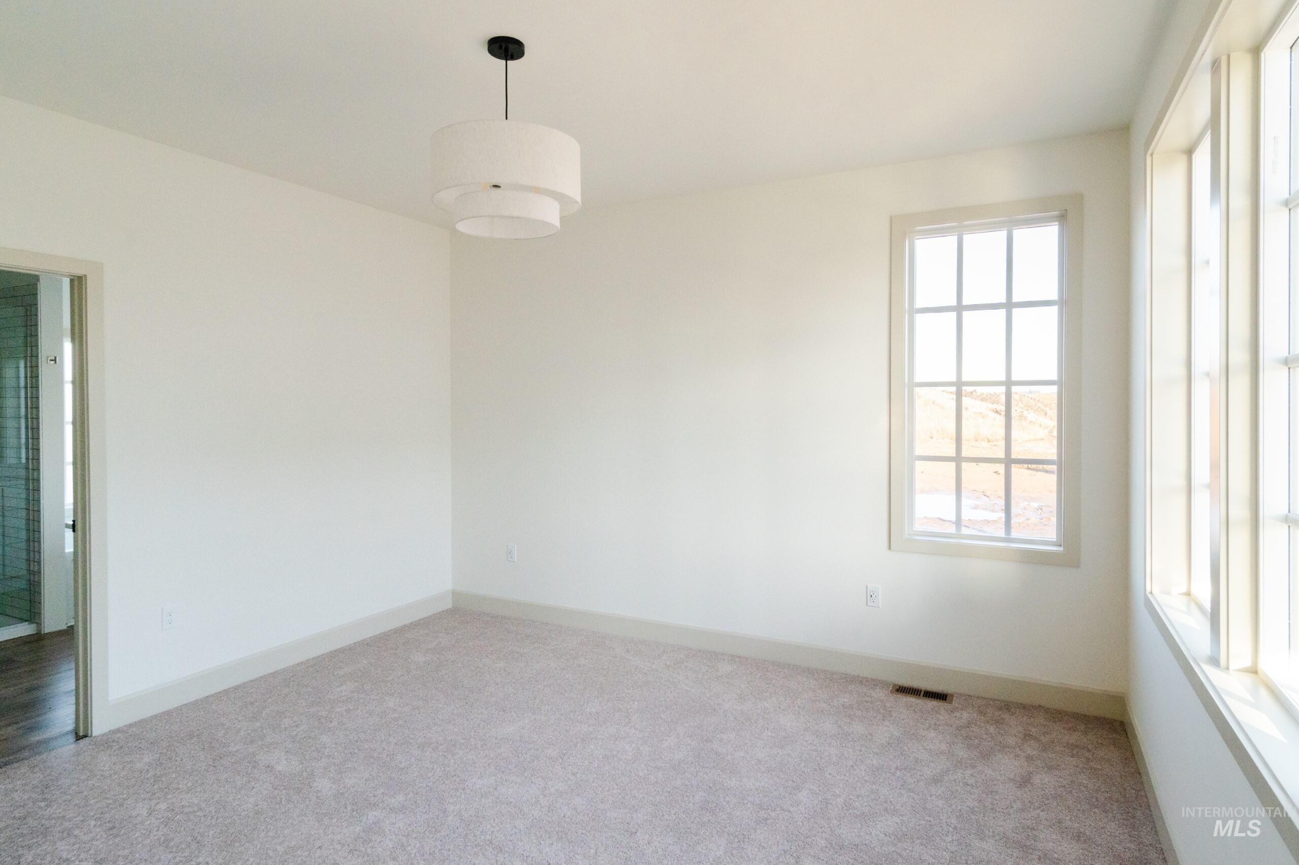 1560 Slonaker, Unit ONYX Moscow, ID 83843 - Photo 17 of 45 Carpeted spare room featuring baseboards