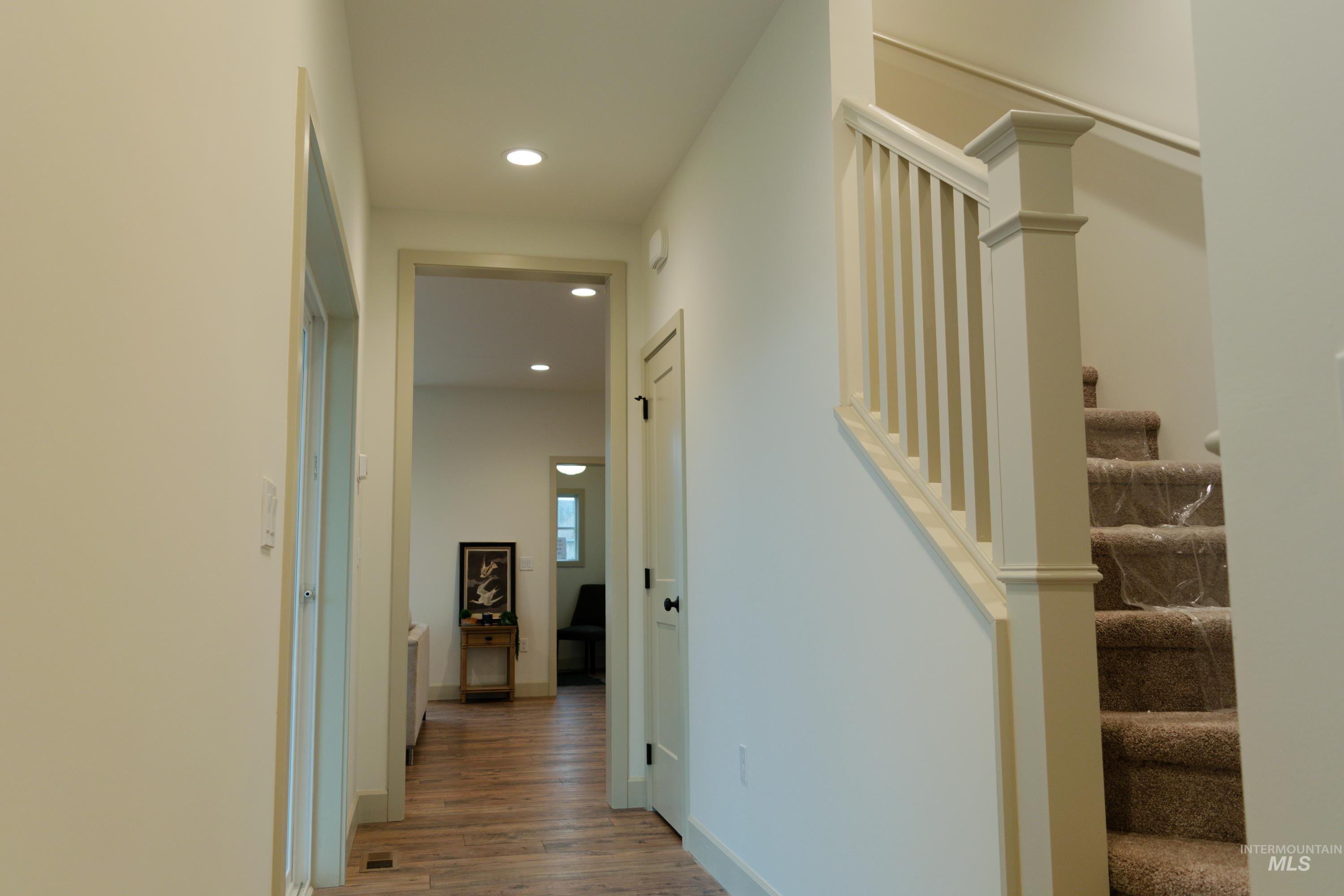 1560 Slonaker, Unit ONYX Moscow, ID 83843 - Photo 19 of 49 Corridor with recessed lighting, stairs, and light wood-type flooring