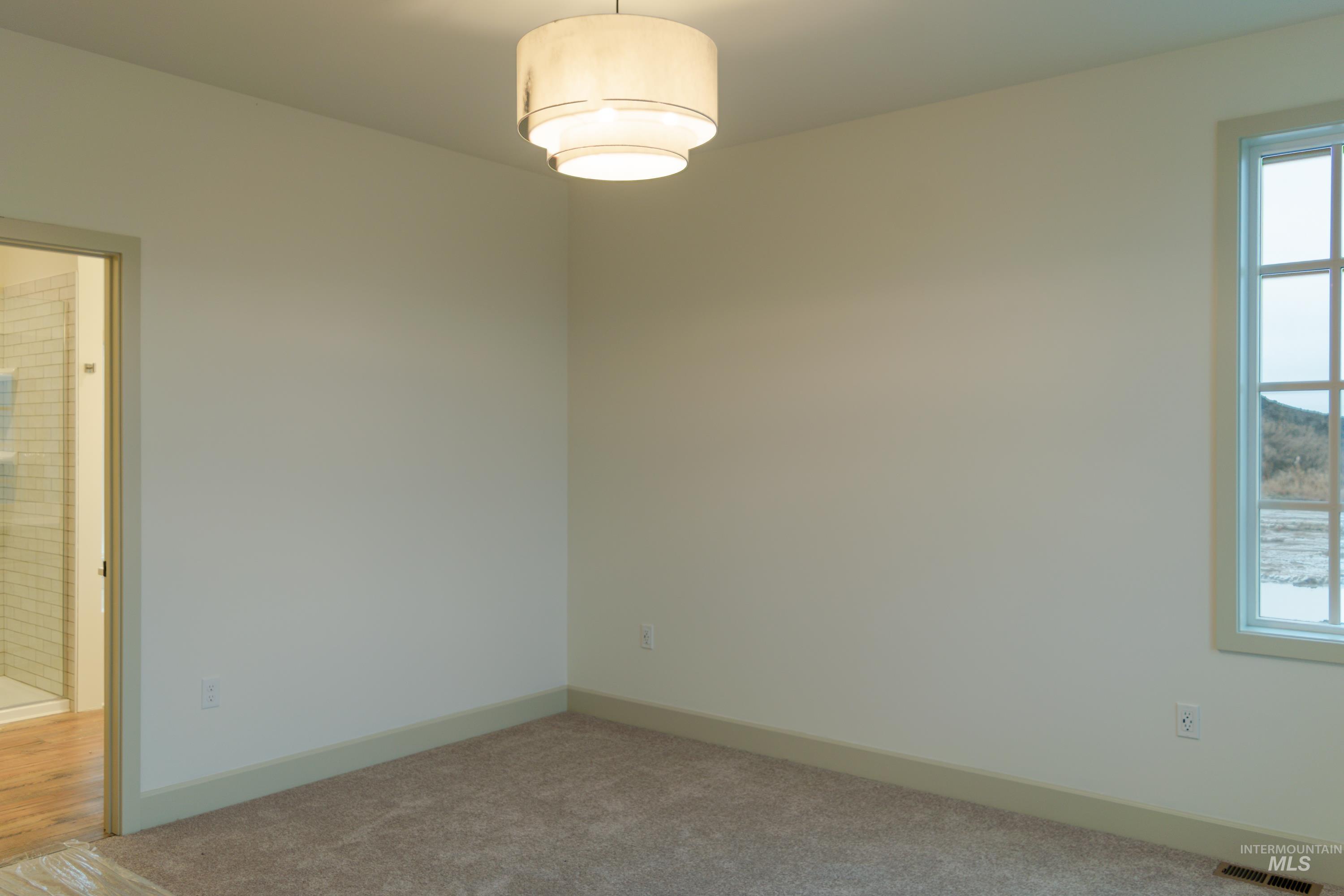 1560 Slonaker, Unit ONYX Moscow, ID 83843 - Photo 20 of 49 Carpeted empty room with baseboards